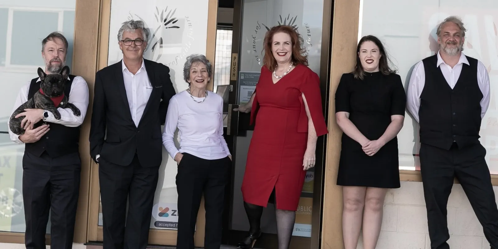 The Bloomfield & Associates team and the office French bulldog outside the Patrick Street office in Hobart